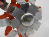 a person holding a metal fan blade in their hand