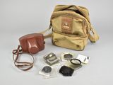 a camera, a camera case, and other items on the table