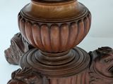 a wooden table with carvings on the top of it