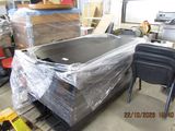 a large metal tub sitting in a warehouse with plastic wrap around it