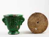 two green vases sitting next to each other on a white surface
