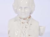 a white bust of a man with a cup in his hand