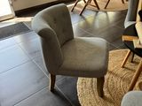 a living room with a couch, chairs, and a table in it