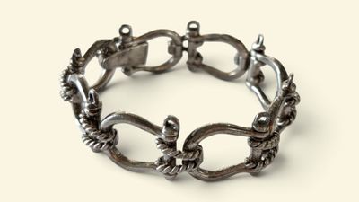 a silver bracelet that has a bunch of charms on it