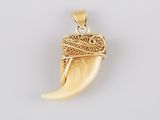 a close up of a pendant on a white surface