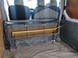 two seats in the back of a van with a heater in the back