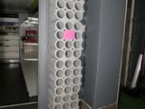 a large stack of wine bottles in the corner of a room