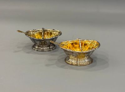 pair of silver and gold plated bowls with spoons and handles