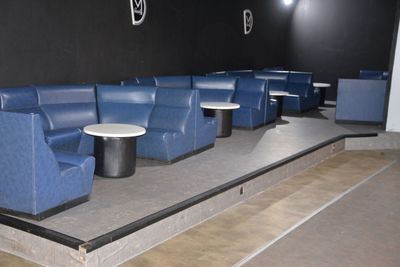 a blue couch and two tables in the middle of a room