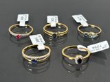 six different colored rings are on display in a display case
