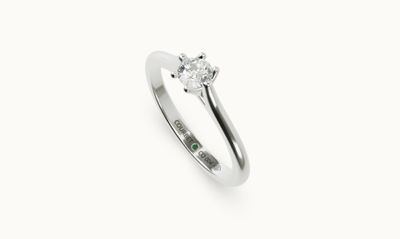 a close up of a diamond ring on a white background