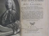 an old book with a picture of a man sitting on a chair