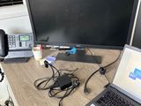 a laptop computer sitting on top of a desk next to a monitor