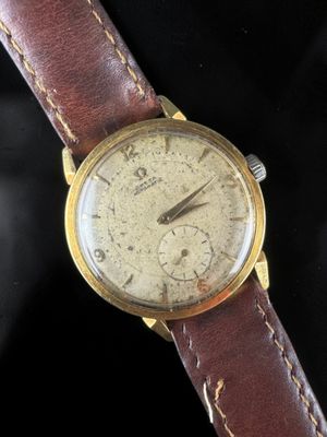 a close up of a wrist watch with a brown leather strap