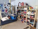 a couch in a room with a lot of clutter on it