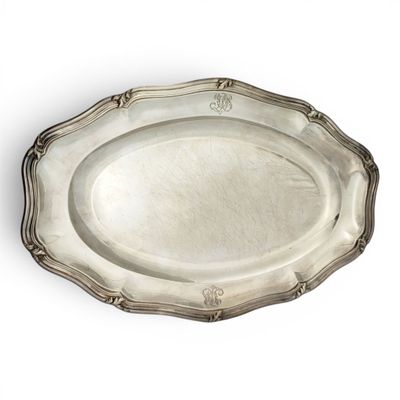 an oval silver plate with a decorative design on the rim