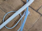 two hoses that are laying on the ground next to each other