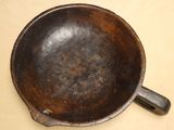 an old frying pan with a handle on a table