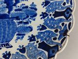 a blue and white plate with a picture of a boat on it