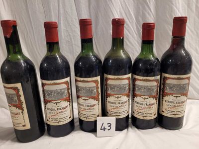 six bottles of wine are lined up in a row on a table