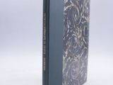 an old book with a black cover and gold writing on it