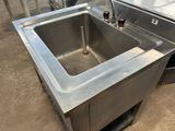 a stainless steel sink with two bottles of beer in it