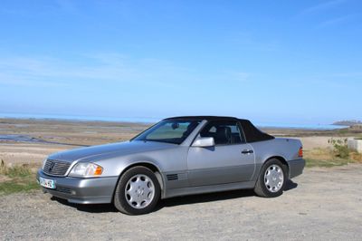 a silver car that is parked on the side of the road