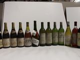 many bottles of wine lined up on a table