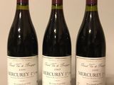 three bottles of wine are lined up in a row on a table