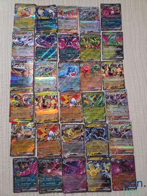 a pile of pokemon cards sitting on top of a table