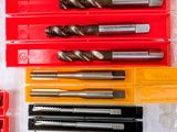 many different types of drill bits in a red case
