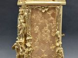 an image of a gold clock with a bird on top of it