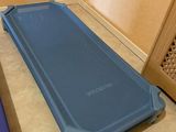 a blue cot that is on the floor in a room