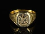 an image of a gold ring with a cross on it