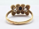 a close up of a gold ring with a blue stone