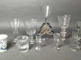 a lot of glasses and cups on the table
