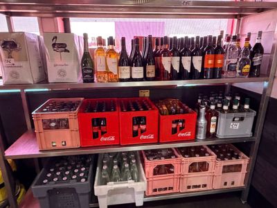 bottles of wine and bottles of beer on a shelf in a store