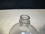 a clear glass bottle sitting on top of a wooden table
