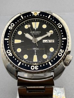 a close up of a wrist watch on a metal stand