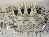 de nombreuses cuillères et fourchettes disposées ensemble sur une table