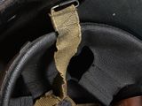a close up of a helmet with a leather strap