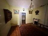 a room with a fireplace and a chandelier hanging from the ceiling