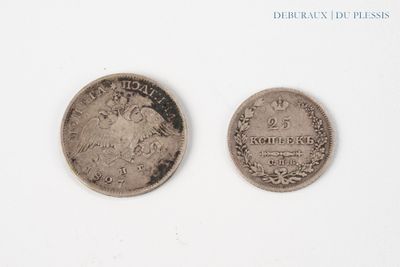 two coins that are sitting side by side on a white surface