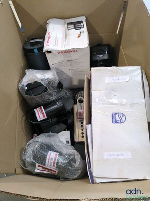 a cardboard box full of assorted electronics and other items