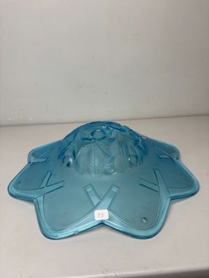 a blue plastic plate with a face on it