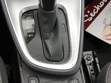 a close up of a car ' s gear lever with a magazine in the background