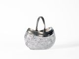 a silver purse with a handle on a white surface