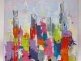 abstract painting of a cityscape in bright colors on a white wall