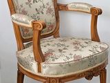 a wooden chair with a floral upholstered seat