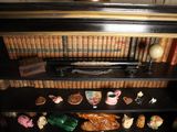 a book shelf with a lot of books and figurines on it